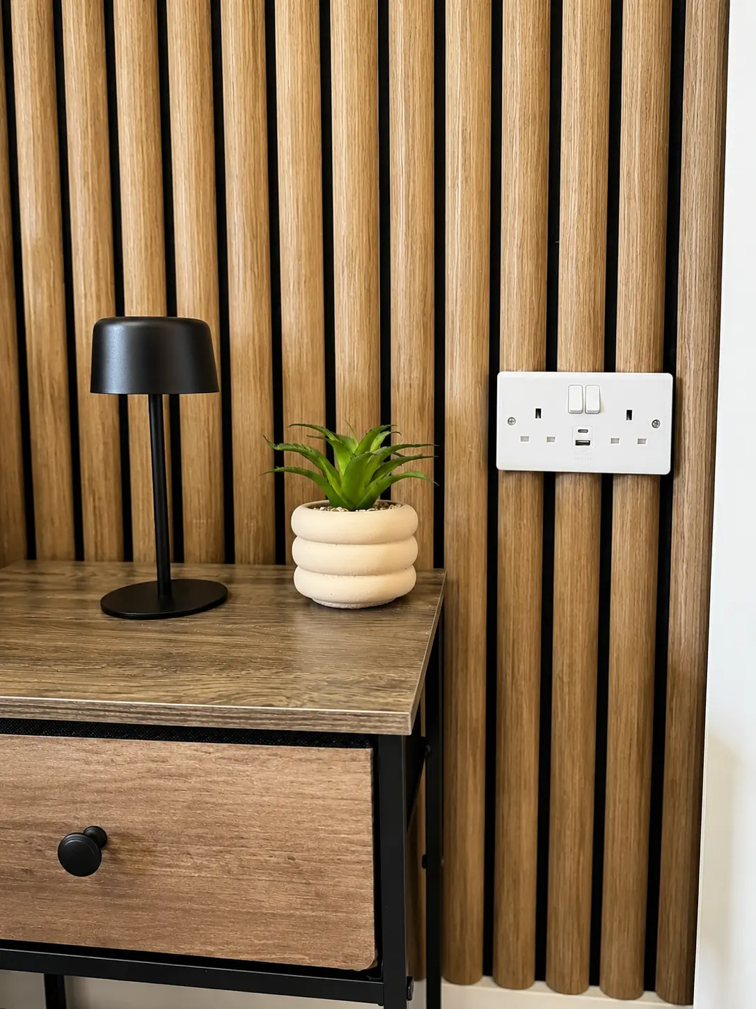 Bedside table detail with lamp and USB sockets at the Wellingborough Luxury Staycation