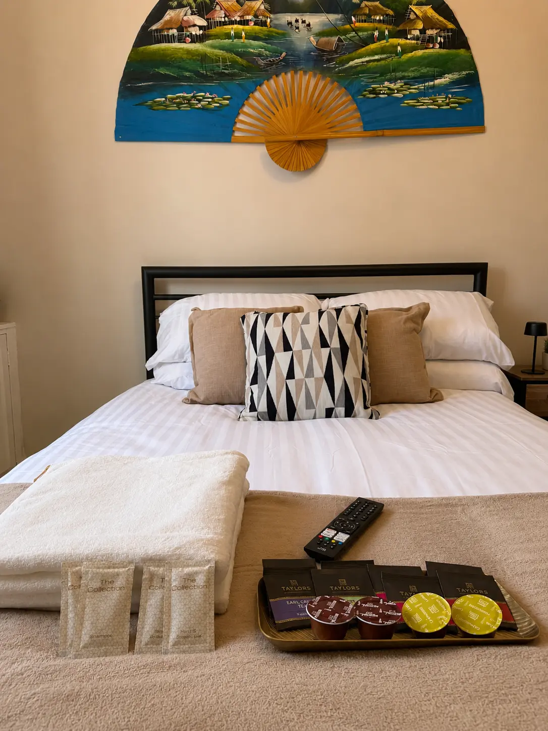 Downstairs bedroom with towels, toiletries and refreshments at the Wellingborough Luxury Staycation
