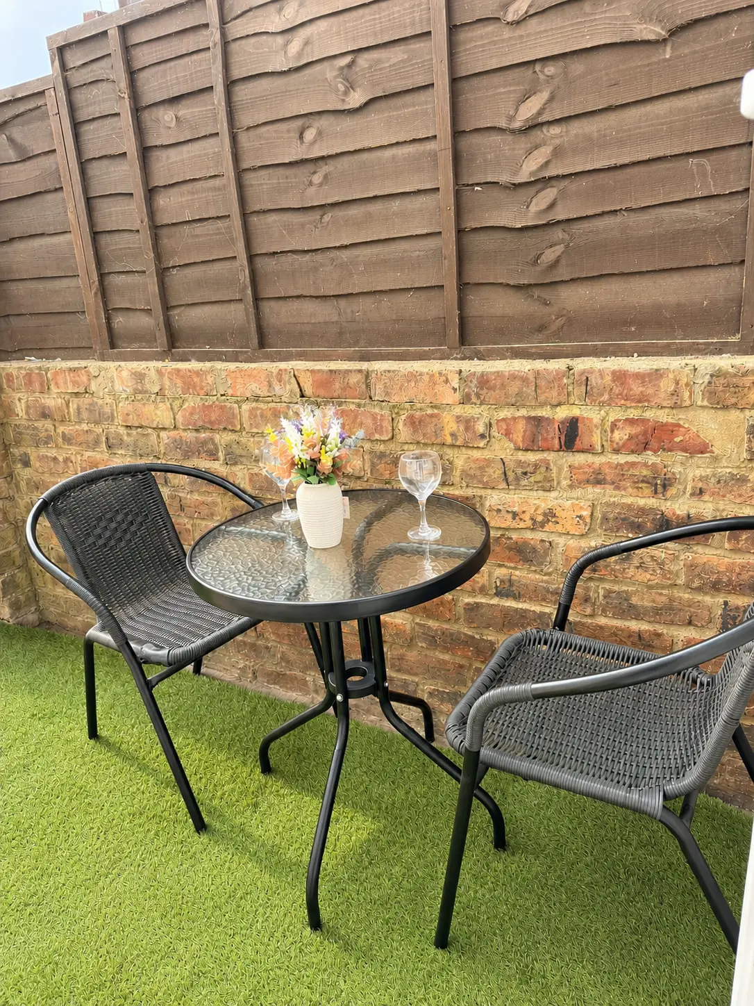 Private rear garden with bistro table and seating at the Wellingborough Luxury Staycation