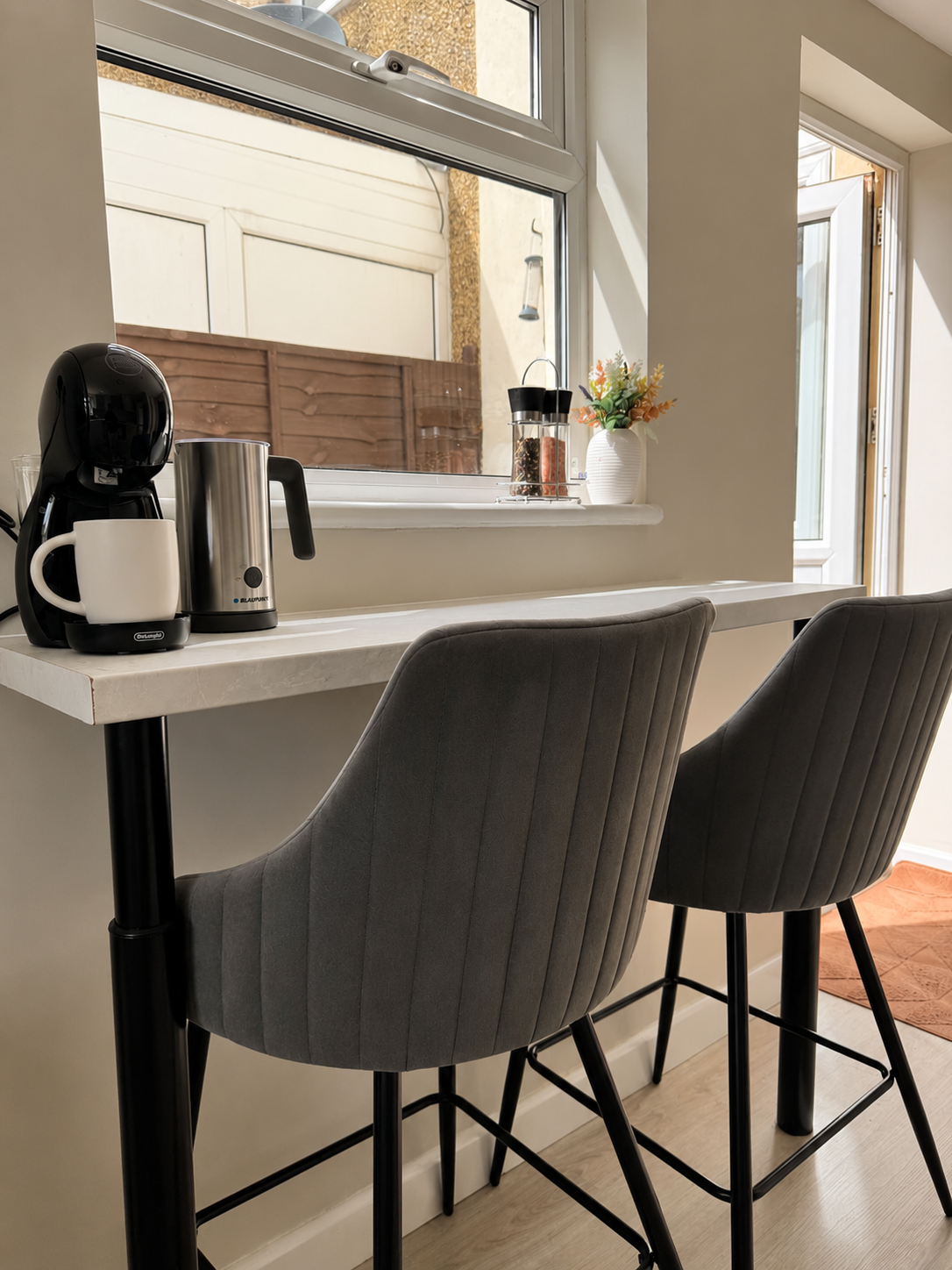 Breakfast bar with coffee machine, milk frother and bar stools at the Wellingborough Luxury Staycation