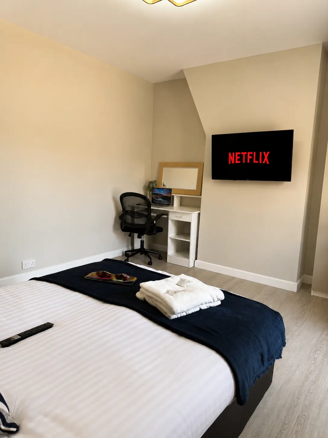 Upstairs main bedroom with wall mounted smart TV and work desk at the Wellingborough Luxury Staycation